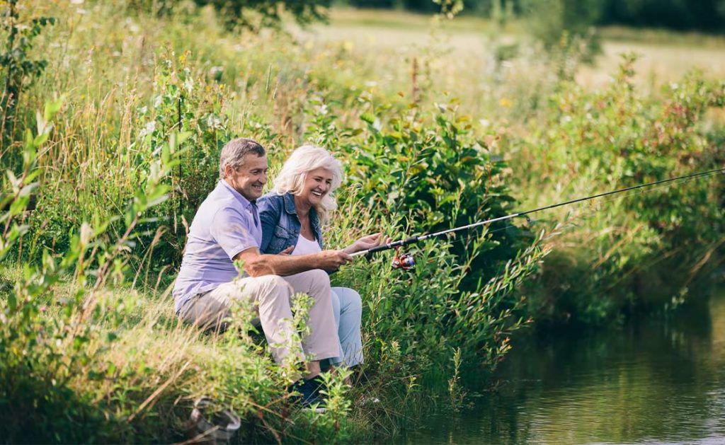 senior couple laughing while fishing wealth management holland oh